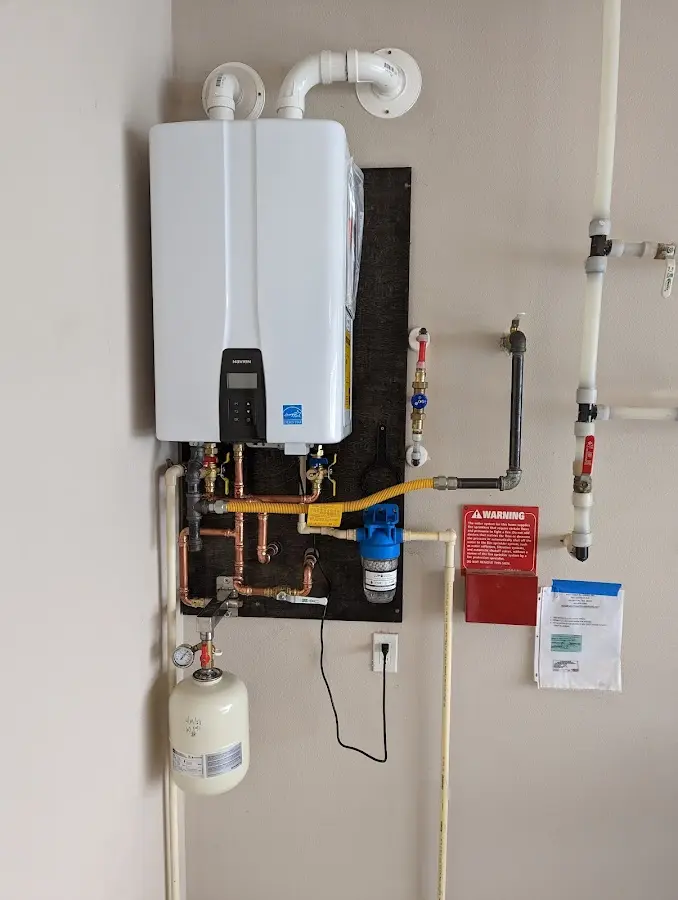 Professional plumber installing copper piping in a Elkins home